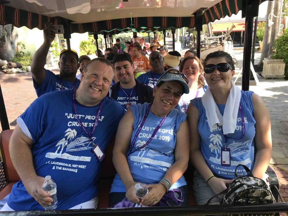 A group of members on a golf cart